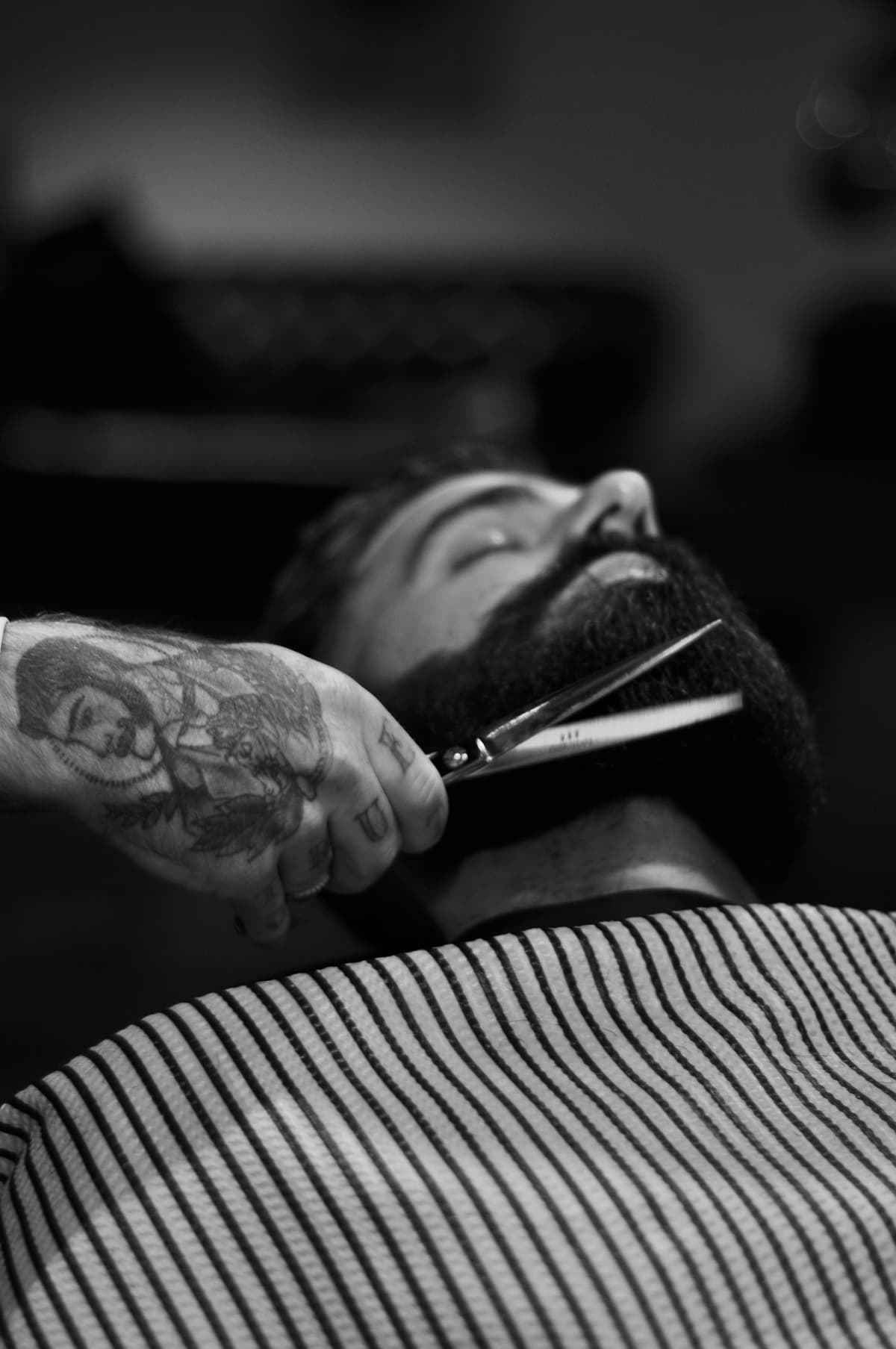 Full beard being scissor-trimmed at the chair